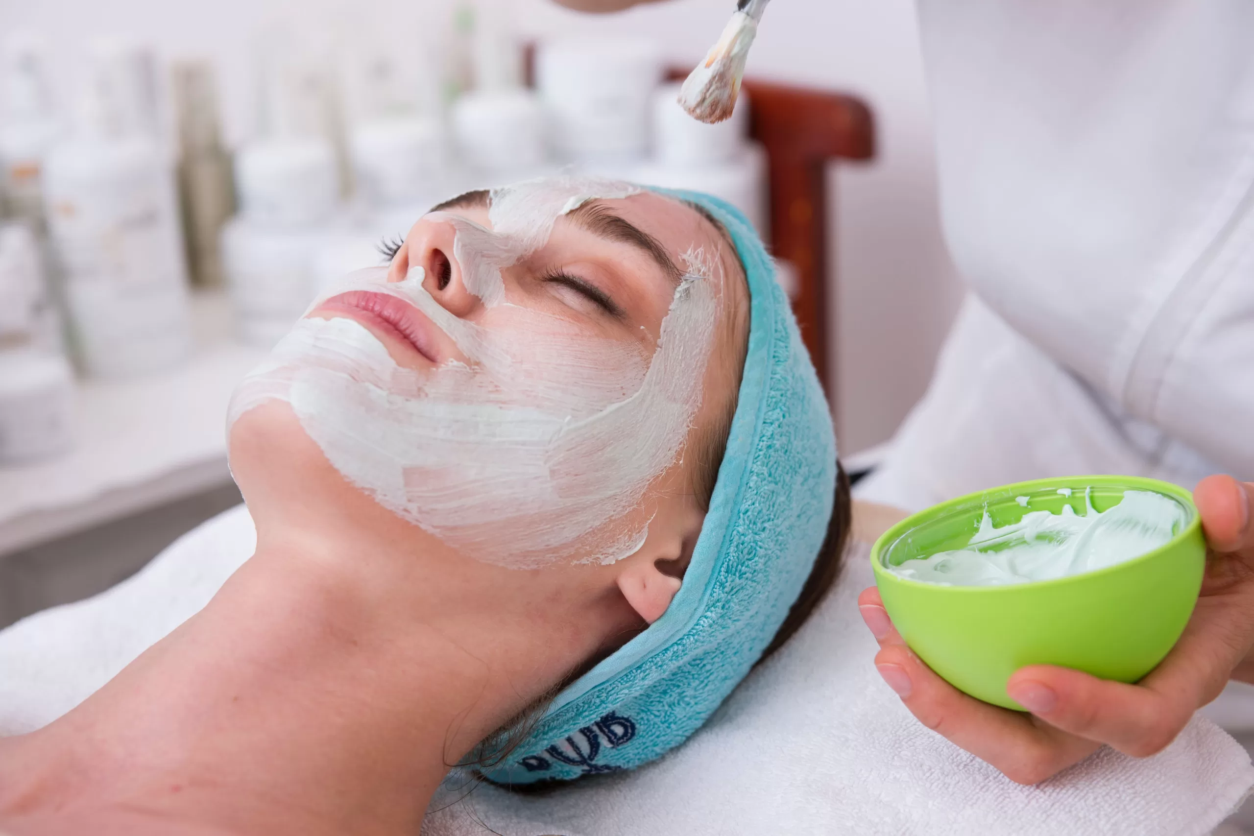 A Girl is lying on the bed, applying a calm clay mask